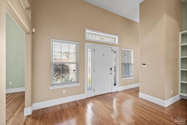 entrance foyer with light hardwood / wood-style floors and a high ceiling