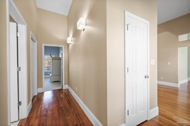 hall with wood-type flooring