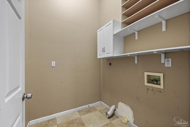 laundry room featuring electric dryer hookup, hookup for a washing machine, and cabinets