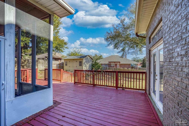 wooden deck with a storage shed