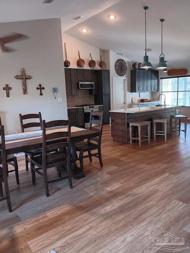 420 Palm Lake Dr, Pensacola, FL 32507 - dining space featuring light wood-style floors and lofted ceiling