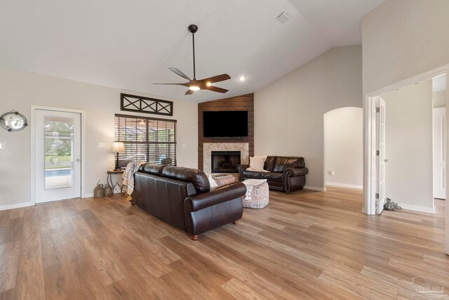 420 Palm Lake Dr, Pensacola, FL 32507 - living room featuring vaulted ceiling, a ceiling fan, a large fireplace, light wood-type flooring, and baseboards