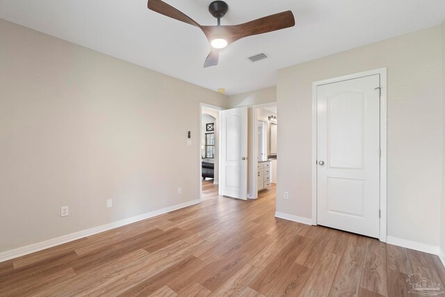 420 Palm Lake Dr, Pensacola, FL 32507 - unfurnished bedroom with light wood finished floors, baseboards, ensuite bathroom, and ceiling fan