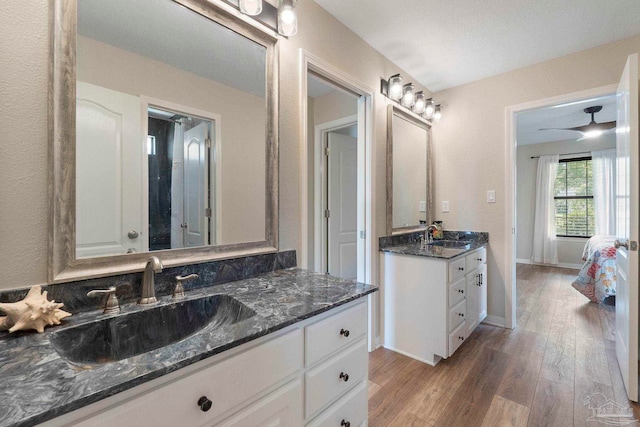 420 Palm Lake Dr, Pensacola, FL 32507 - full bathroom with two vanities, wood finished floors, and baseboards
