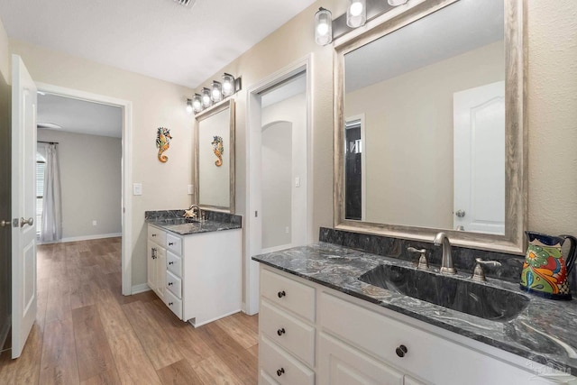 420 Palm Lake Dr, Pensacola, FL 32507 - full bath featuring wood finished floors, two vanities, and baseboards
