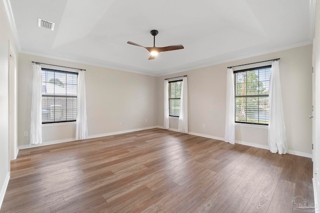 420 Palm Lake Dr, Pensacola, FL 32507 - spare room with light wood-type flooring, plenty of natural light, a tray ceiling, and ornamental molding