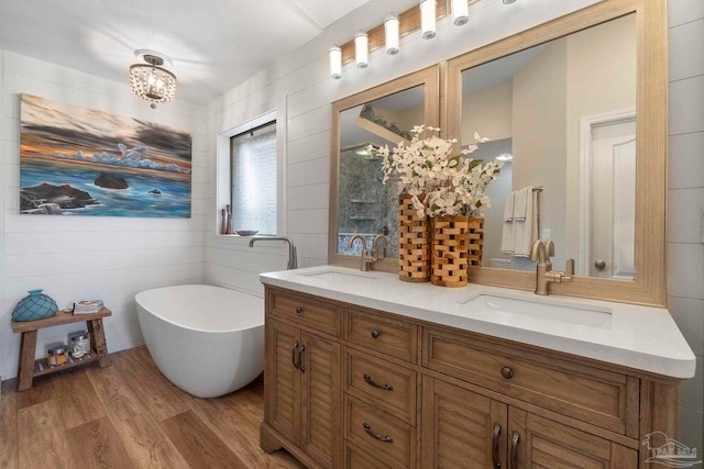 420 Palm Lake Dr, Pensacola, FL 32507 - full bath with double vanity, a soaking tub, and wood finished floors