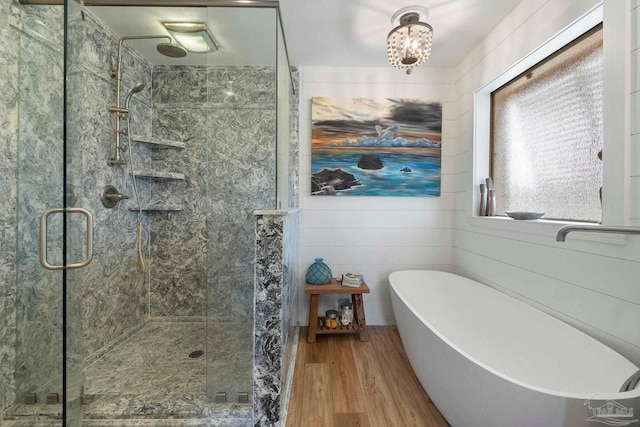 420 Palm Lake Dr, Pensacola, FL 32507 - full bathroom featuring a stall shower, wood finished floors, and a freestanding tub