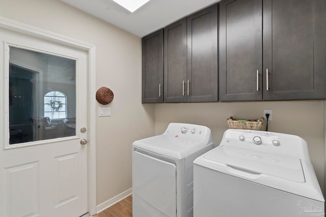 420 Palm Lake Dr, Pensacola, FL 32507 - laundry area with washer and clothes dryer, cabinet space, baseboards, and light wood-style flooring