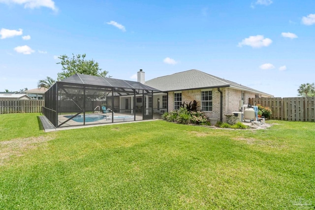 420 Palm Lake Dr, Pensacola, FL 32507 - back of house featuring brick siding, a patio, a chimney, and glass enclosure