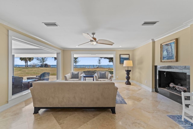 living room with crown molding, visible vents, a fireplace, and baseboards