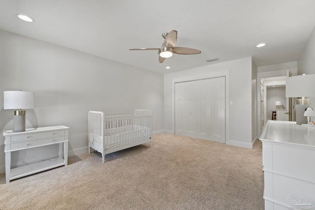 carpeted bedroom with recessed lighting, a closet, visible vents, and baseboards