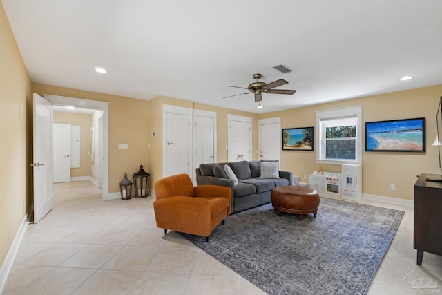 living area with light tile patterned floors, baseboards, visible vents, ceiling fan, and recessed lighting