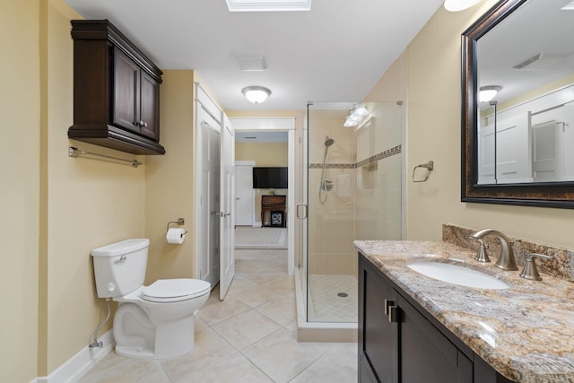 bathroom featuring visible vents, toilet, a stall shower, vanity, and tile patterned floors