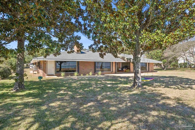 single story home with a front lawn and brick siding