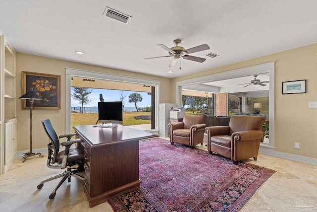 home office featuring a ceiling fan, visible vents, and baseboards