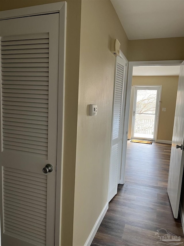 hallway with dark hardwood / wood-style floors