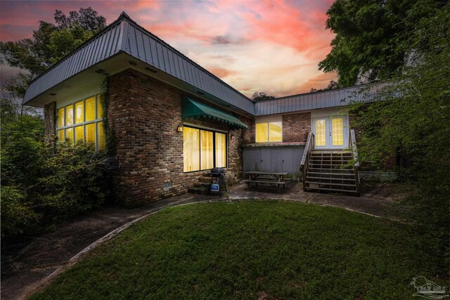 back house at dusk with a yard