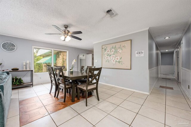 dining area with crown molding, a textured ceiling, ceiling fan, and light tile patterned floors