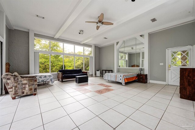 tiled bedroom featuring expansive windows, ceiling fan, and beam ceiling