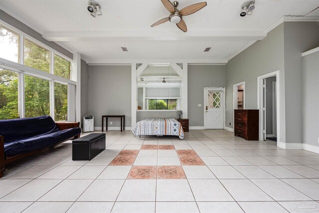 bedroom featuring beamed ceiling, multiple windows, light tile patterned floors, and ceiling fan