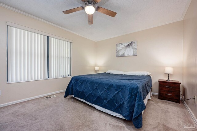 bedroom with multiple windows, ceiling fan, and light colored carpet