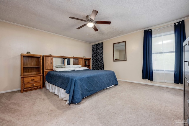 carpeted bedroom with a textured ceiling, ceiling fan, and crown molding