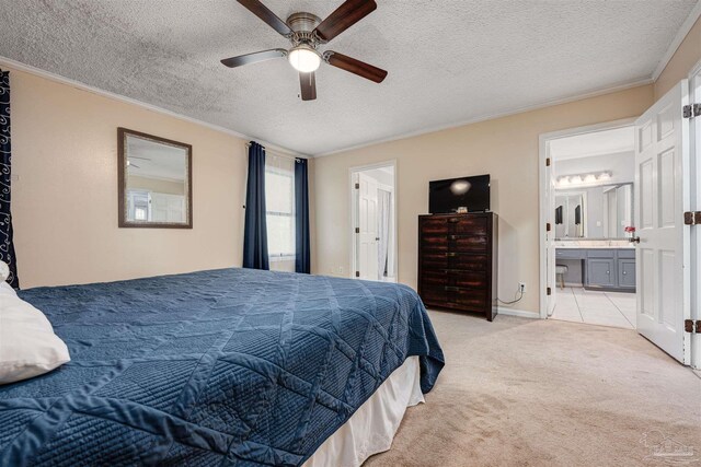 bedroom featuring ensuite bath, a textured ceiling, light tile patterned flooring, ceiling fan, and ornamental molding