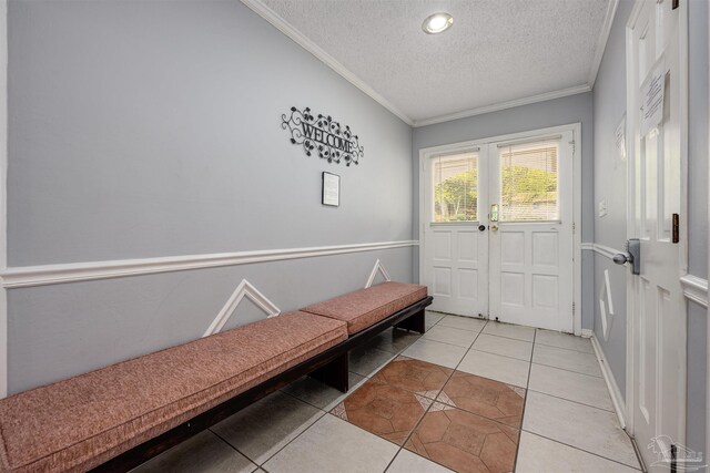 interior space with light tile patterned flooring, crown molding, and a textured ceiling