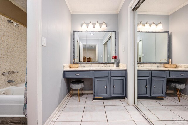 bathroom with crown molding, a textured ceiling, tile patterned floors, and double sink vanity