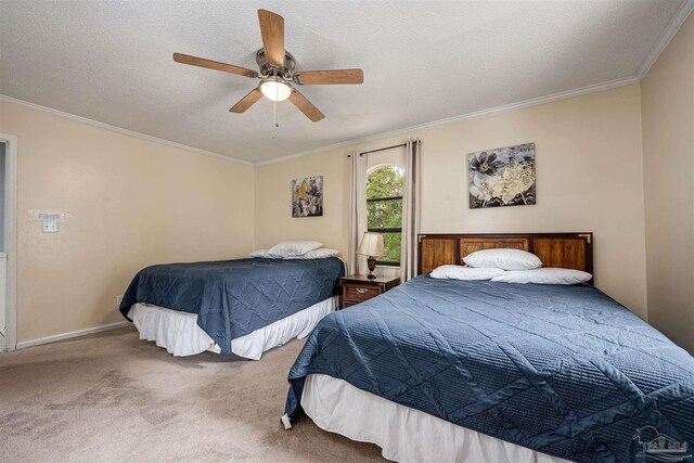 bedroom with ornamental molding, carpet, a textured ceiling, and ceiling fan