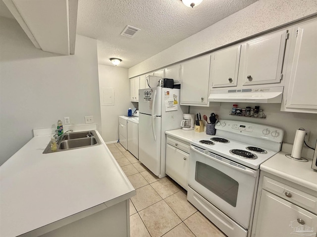 kitchen with light countertops, a sink, white appliances, independent washer and dryer, and under cabinet range hood