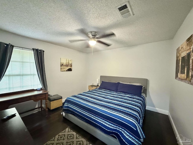 bedroom featuring visible vents, ceiling fan, a textured ceiling, and baseboards