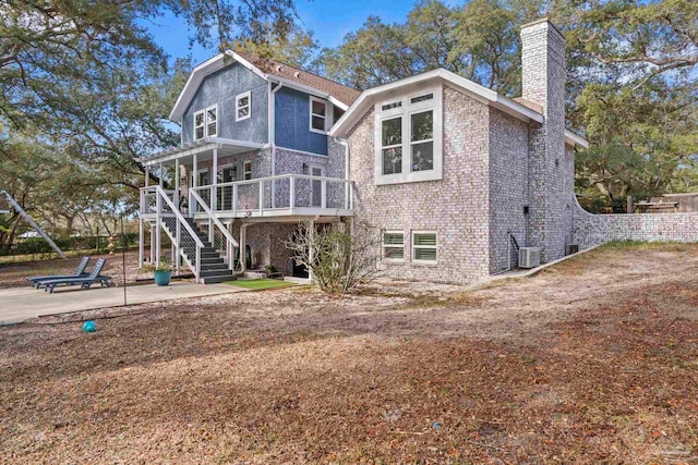 back of property with cooling unit, a pergola, a wooden deck, and a patio