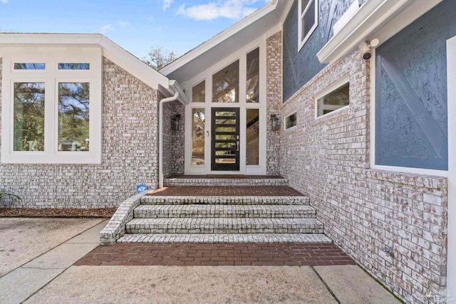 view of exterior entry with a patio