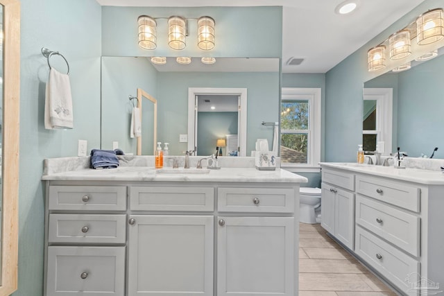 bathroom featuring toilet and vanity