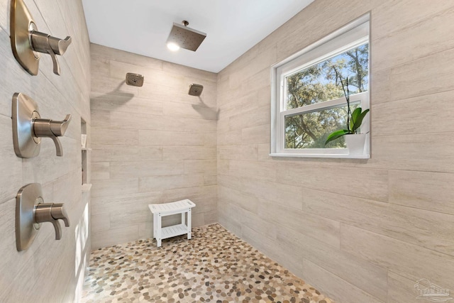 bathroom with tiled shower