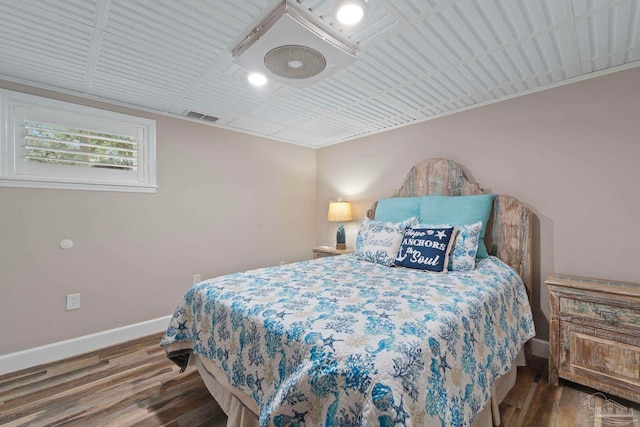 bedroom with wood-type flooring