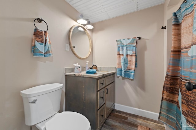 bathroom featuring toilet, vanity, and wood-type flooring