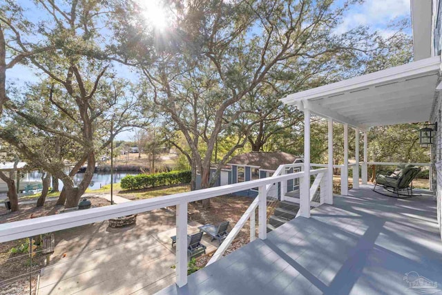 deck featuring a storage unit and a water view