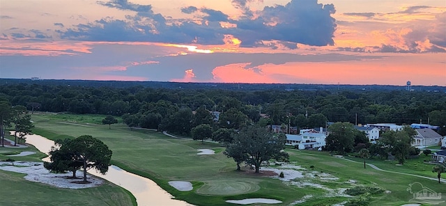 aerial view at dusk featuring a water view