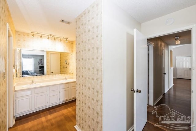 2299 Scenic Hwy Unit T7, Pensacola, FL 32503 - bathroom with wood finished floors, double vanity, baseboards, and connected bathroom