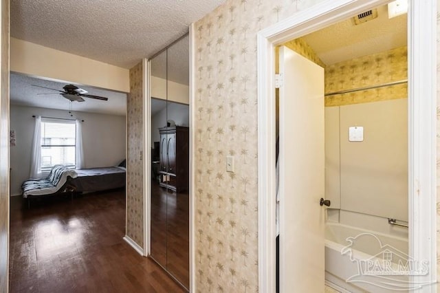 2299 Scenic Hwy Unit T7, Pensacola, FL 32503 - bathroom featuring wood finished floors, wallpapered walls, a textured ceiling, ceiling fan, and a bath