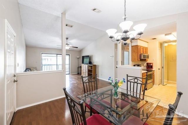 2299 Scenic Hwy Unit T7, Pensacola, FL 32503 - dining room with a chandelier, a ceiling fan, light wood-style floors, vaulted ceiling, and baseboards