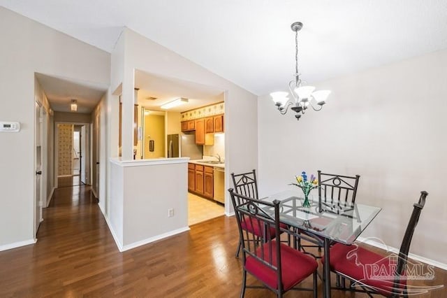 2299 Scenic Hwy Unit T7, Pensacola, FL 32503 - dining space featuring a chandelier, dark wood finished floors, and baseboards