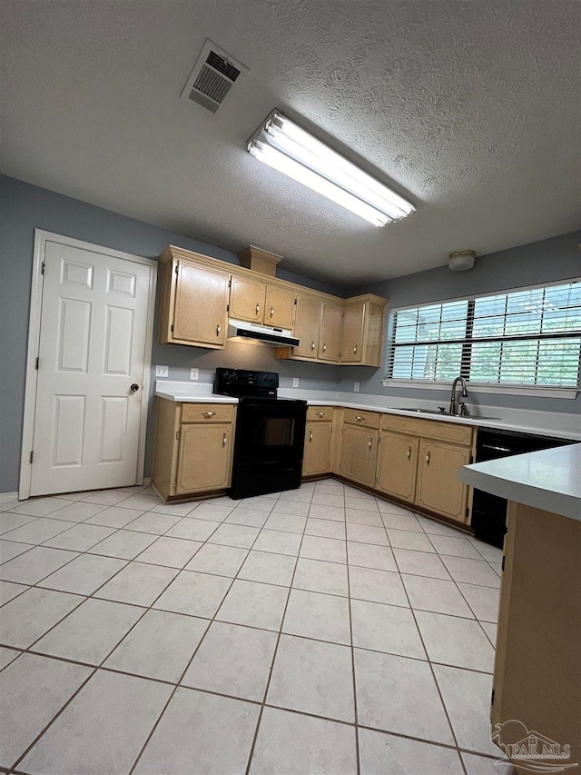 kitchen with light tile patterned flooring, a textured ceiling, sink, and black electric range