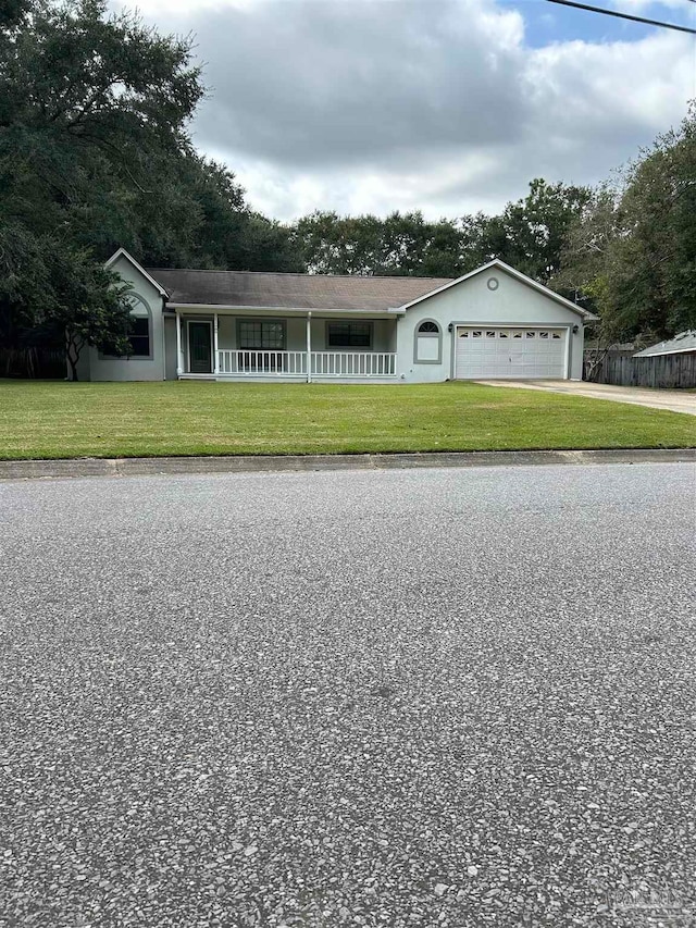 ranch-style home with a porch, a front yard, and a garage