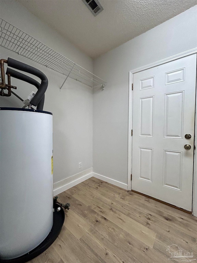 utility room featuring water heater