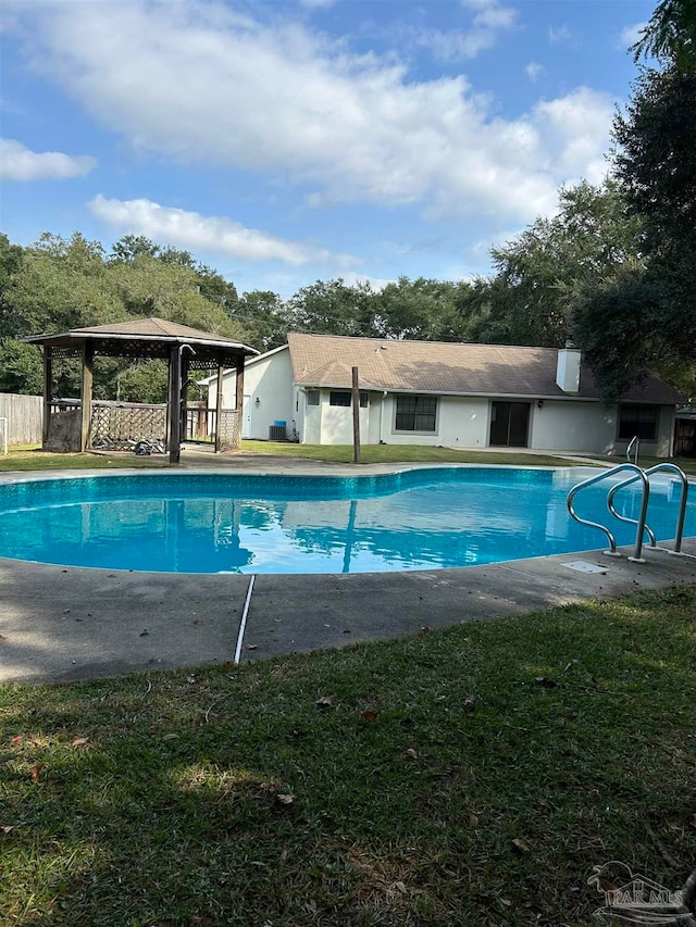 view of pool with a lawn and a patio area