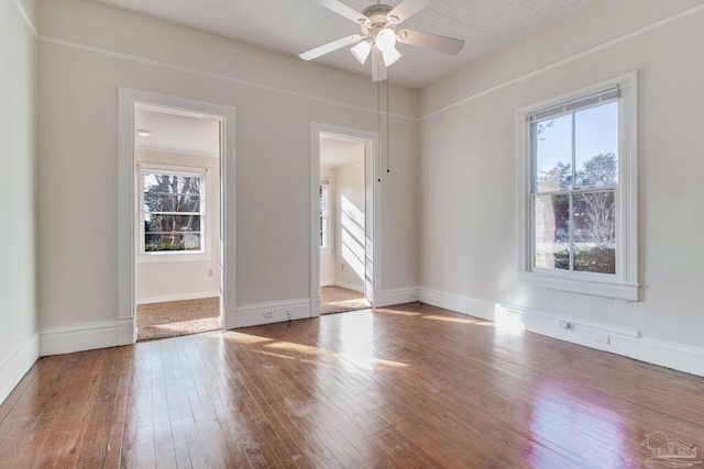 empty room with hardwood / wood-style flooring and ceiling fan